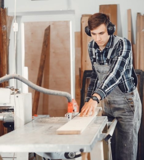 the-carpenter-works-with-a-tree-WAFRT59